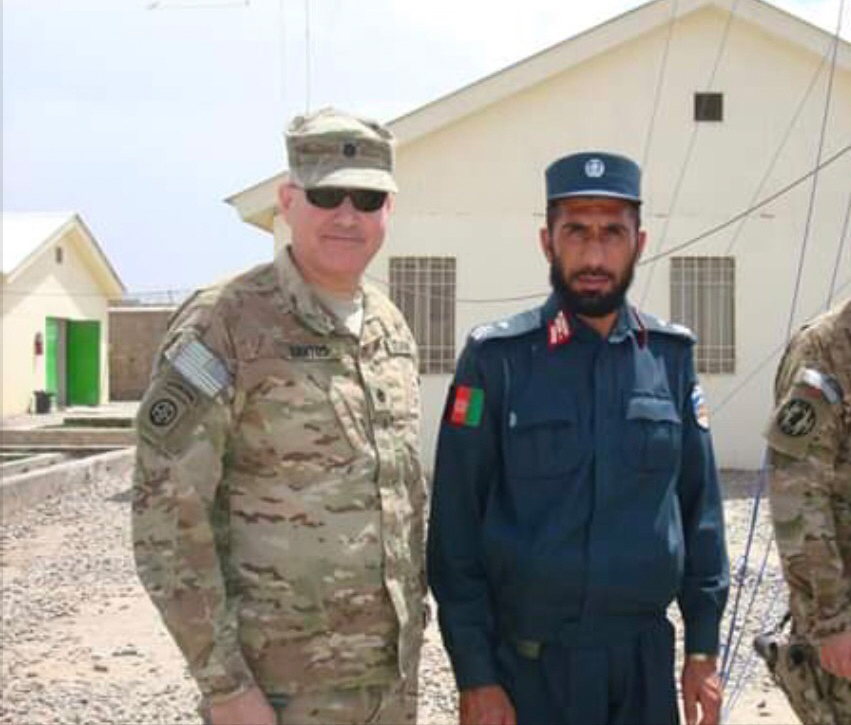 Al Santos standing with a military member in the Middle East