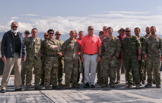 Al Santos standing with a large group of members of the military