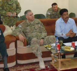 Al Santos in the military sitting down with other leaders
